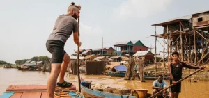 Tonle Sap floating village boat tour with local houses on stilts and scenic views, part of a private Siem Reap city and cultural day tour.
