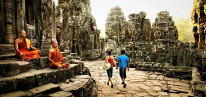 Traveler biking through Angkor jungle trails on a private cycling adventure past ancient temples and lush forests in Cambodia.