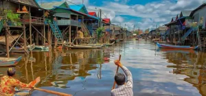 Tonle Sap floating village boat tour with local houses on stilts and scenic views, part of a private Siem Reap city and cultural day tour.