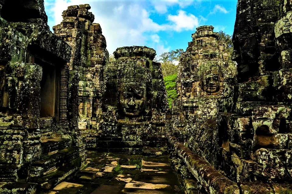 Carved face towers lining a stone courtyard at the Bayon temple